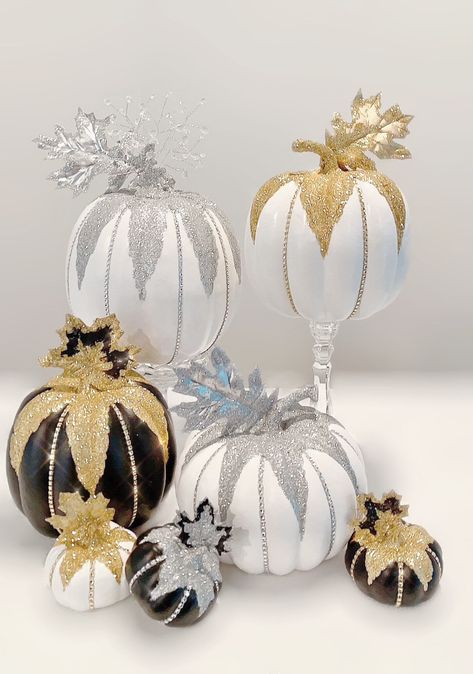 Add some gold and white fall/winter glam accented with shimmering gold glitter and gold faux jewels to create an enchanting display.  Purchase includes either: 1 extra large 13 inch x 11 inch gold and white pumpkin with gold sparkle leaf and embellished spray, 1 large 10 inch x 9 inch gold and white pumpkin with gold sparkle leaf or 1 small 4 inch x 4 inch gold and white pumpkin with gold sparkle leaf.  Measurements include leaf and jeweled embellishments. Please note: only the extra large size Pumpkin Decorating Diy, Pumpkin Inspiration, Winter Glam, Mackenzie Childs Inspired, Pumpkin Contest, Fun Fall Crafts, Pretty Pumpkins, Halloween Party Outfits, Elegant Halloween