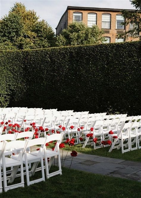 Imagine being led down the aisle by these exquisite red roses surrounded by a picturesque garden setting at this outdoor wedding ceremony. Walking down the aisle accompanied by a live harpist is so elegant. #outdoorweddingceremony #outdoorwedding #weddingceremony #redroses #harpist #weddingmusic #overthemoon #townandcountrymag #theknot #weddingplanner #nycweddingplanner #luxuryweddings #alinatoevents Wedding Aisle Red, Picturesque Garden, White Wedding Ceremony, Red Wedding Decorations, Rose Gown, Wedding Isles, Red And White Weddings, Rose Petals Wedding, Ceremony Chairs