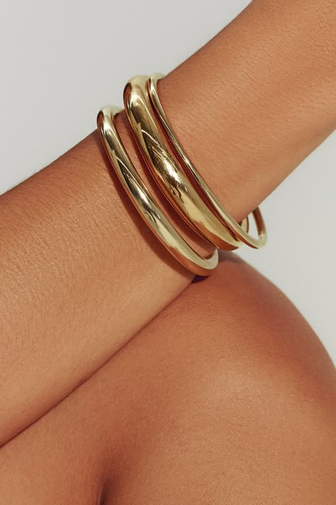 Filled with 18K gold, our Brazil-made tube cuff is the dynamic final touch – or the gleaming foundation of a sculptural bracelet stack. Mix in varying widths and finishes for the most impact. Jewelry Collection Handcrafted in Brazil 18K Gold Filled Thickness: 8.4mm Inner Diameter: 2.5" Opening: 1.25" Weight: 0.38 oz Waterproof Hypoallergenic Gold Necklace And Bracelet, Gold Jewelry Brands, Bracelet Layering Ideas Gold, Big Gold Bangles, Chunky Gold Bangle, Gold Bracelets Bangles, Gold Jewelry Fashion Bracelet, Gold Bracelet Thick, Gold Cuff Necklace