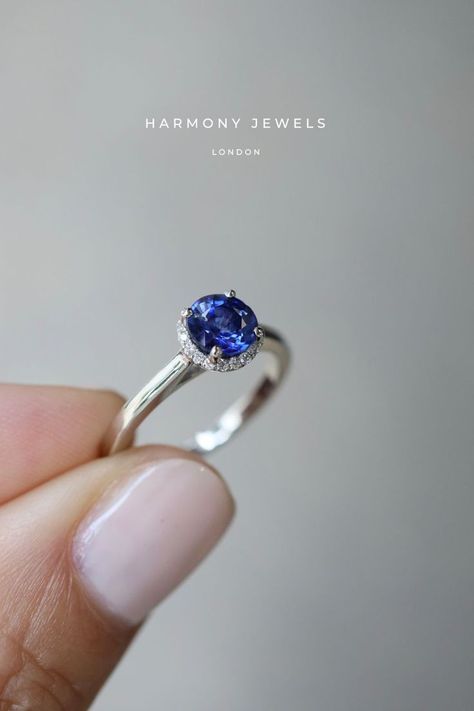 A Round Blue Sapphire and Diamond halo engagement ring is a classic choice for a reason and will never go out of style Round Sapphire Engagement Ring, Round Sapphire Ring, Solitaire Halo Engagement Ring, Engament Rings, Halo Round Engagement Ring, Get Engaged, Blue Sapphire Engagement Ring, Sapphire Wedding Band, Colored Engagement Rings