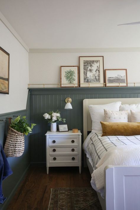 Panelled bedroom with shelf and brass rail above bed. V-groove panelling and wallpaper. Peg Rail. Vintage Rug. Farrow and Ball wallpaper and Old White painted bed. Schoolhouse Electric brass sconce. Styled bed with textured pillows. Oak hardwood floors. Picture gallery. Brass Rail, Shelf Above Bed, Wall Decor Above Bed, Wall Panels Bedroom, Decor Above Bed, Bedroom Reveal, Moody Bedroom, Home Design Diy, Bedroom Panel