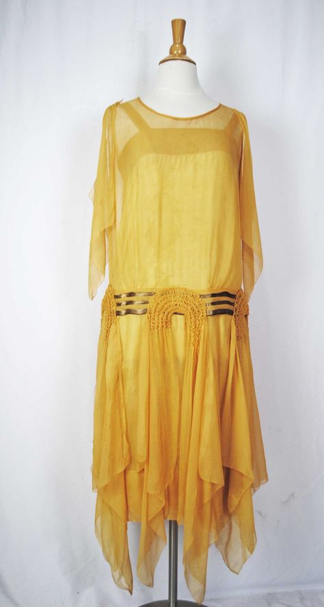 "VINTAGE SHEER YELLOW SILK CHIFFON DAY DRESS, c1930s This 1930s day dress constructed with a sheer yellow silk chiffon and the skirt has a wonderful flow as you walk.  This dress has a no sleeves, no fastening closures and is a slip on dress with its original yellow slip. The dress has  three bands of silver lame ribbon accented its drop waist and with three U shaped ruched appliques with two long streamers dangling of each downturn corner flowing past the hemline. Accenting the shoulder are lon Vintage Chiffon Dress, 1930s Day Dress, Mermaid School, Paisley Shawl, 1920 Fashion, Slip On Dress, Yellow Silk, 1920s Dress, Dropwaist Dress