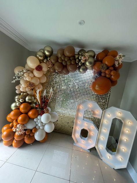 Burnt Orange balloon display with gold sequin wall and light up numbers Orange And Brown Balloon Garland, Burnt Orange Decorations Party, Burnt Orange Balloon Arch, Burnt Orange Birthday Party, Orange And Silver Party Decorations, Orange And Gold Birthday Decorations, Terracotta Balloon Garland, Orange And Gold Party Decor, Burnt Orange Balloon Garland