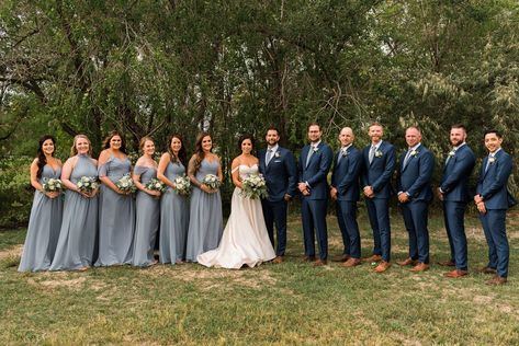 Bridesmaids in dusty blue dresses mismatched. Groomsmen in navy blue suits. See more from this fall outdoor wedding in Fort Collins, CO on the blog. #dustybluewedding Navy Tux With Dusty Blue, Dusty Blue Bridesmaid Dress With Groomsmen, Cornflower Blue Groomsmen, Light Navy Groomsmen Suits, Navy Blue Suit With Dusty Blue Tie, Blue Groom Navy Groomsmen, Groomsmen In Navy Blue, Dusty Blue And Navy Bridal Party, Dusty Navy Bridesmaid Dresses