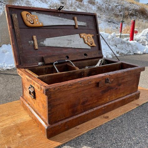 Hand crafted antique carpenter’s tool chest constructed of tight grain Douglas Fir having single loose tool interior box, heavy-duty iron drop handles, steel chain lid catch, and faux raised top, with signature two saw custom maple mounts underside of top lid, and what seems to be a more recently done hand painted artist interpretation of the Colorado flag (can faintly make out the old etching burned into the wood underneath) which apparently had been executed by the Carpenter whom originally ha Carpenters Workbench, Wood Christmas Gifts, Wooden Tool Chest, Wood Toolbox, Wood Tool Chest, Woodshop Tools, Old Tool Boxes, Antique Hand Tools, Tack Trunk