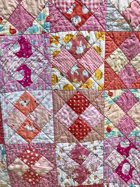 This adorable baby quilt measures 40 x 54 inches and is made lovingly from 100% cotton fabric, batting and thread. I used adorable prints in pinks and corals with other harmonious colors for the patchwork pattern in the top, and arranged them light to dark to promote contrast. Each print is cuter than the last! I added a backing and border in colors and prints that complement those in the quilt top. The result is a cheery pattern that will please any happy baby. This quilt can be used for years 4 Patch Quilts, Simple Quilt Patterns, Amische Quilts, Economy Block, Monochromatic Quilt, Patchwork Squares, American Patchwork And Quilting, Pink Quilt, Charm Pack Quilts