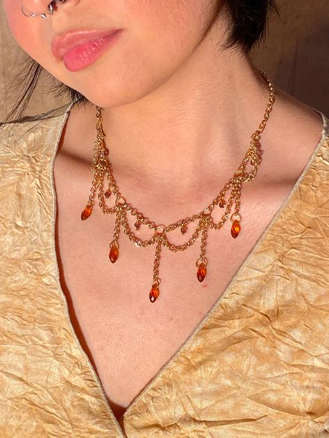 This beautiful Amber Drop Necklace is one that is timeless and elegant! It is made with iron chain and plastic beads, so to prolong its life, do not wear in water.  17.5 inch long chain Please message me with any questions or concerns!