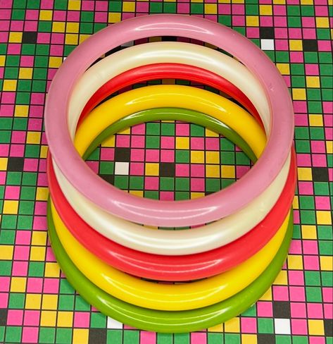 Set of five matching bangles, 1980’s Round plastic Bangles, Unused. 🟡🔴🟢⚪️🟣🔵🟡🔴🟢⚪️🟣🔵 You can make a perfect bangle stack with these bright colored bangles. 🔗 Link in bio 🔗 #bangles #bangle #banglestack #banglestacks #bracelet #colourpop #colorpop #acrylicjewelry #pinup #retro #rockabilly #accessories #etsy #etsyshop #etsyseller #etsylove #jewelry #vintagestyle #midcentury #vintagebangle #plasticbangle #pinkbangle #yellowbangle #juicyfruitbrooches #summerjewelry #80s #80sfashion Rockabilly Accessories, Bangle Stack, Backyard Flowers, Plastic Bangles, Vintage Bangles, Amazing Gifts, Juicy Fruit, Stacked Bangles, Acrylic Jewellery