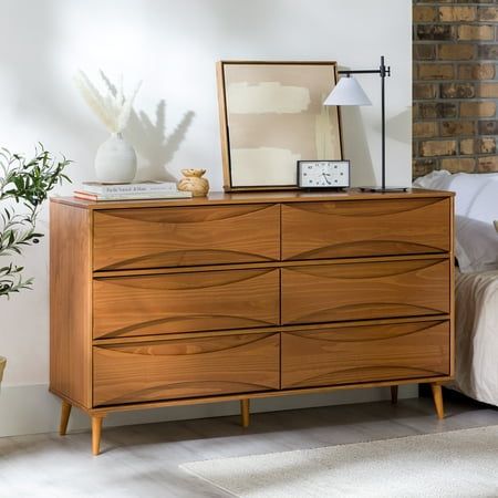 Add a stylish and practical dresser to your home with the Walker Edison 58 Mid-Century Modern Curved Front 6-Drawer Dresser. This eye-catching dresser features unique, curved detailing on the front of the drawers, which gives it a retro-inspired look that is sure to stand out. The tapered legs add an extra touch of style, while the six spacious drawers provide plenty of room for storing the essentials. Made from responsibly harvested solid pine wood, this dresser is both environmentally friendly and long-lasting. Color: Brown. Designer Dresser Furniture, Dresser Maximalist, Mid Century Modern Bedroom Dresser, Mcm Bedroom Furniture, Walnut Dresser Bedroom, 50s Dresser, Retro Dressers, Affordable Dresser, 70s Dresser