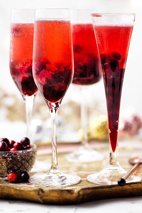 Festive fruit gives this Kir Royale an extra special twist. With a syrup made from cranberries, Crème de Cassis and sugar this Champagne cocktail is the perfect Christmas party idea. | Tesco Cranberry Bellini Recipe, Cocktail Recipes Christmas, Healthy Cocktail Recipes, Cranberry Drinks, New Years Cocktails, Kir Royale, Dinner Party Desserts, Drinks Ideas, Champagne Cocktails