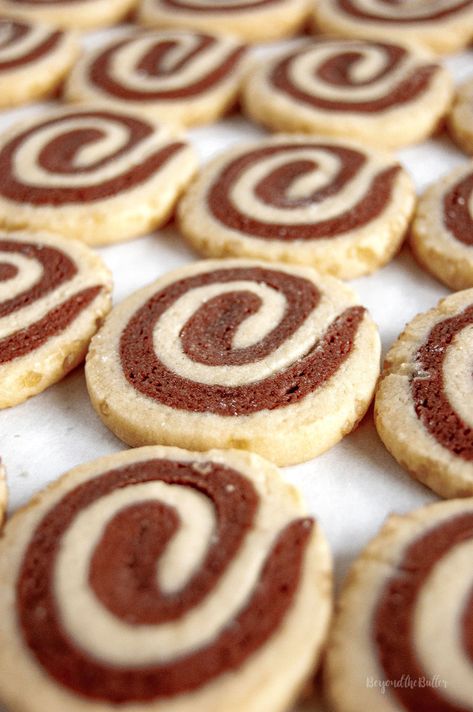 Chocolate Pinwheel Cookies are perfect to make over the holidays! You take chocolate cookie dough and roll it with some vanilla cookie dough. Roll the cookie dough log in some demerara sugar for a bit of sweet crunchiness on the outside! #holidaycookies #pinwheelcookies #chocolatepinwheelcookies #cookies #holidaydesserts #beyondthebutter Pinwheel Cookie Recipes, Chocolate Pinwheel Cookies, Chocolate And Vanilla Swirl, Vanilla Cookie Dough, Holidays Treats, Pinwheel Cookies Recipe, Swirl Cookies, Demerara Sugar, Icebox Cookies