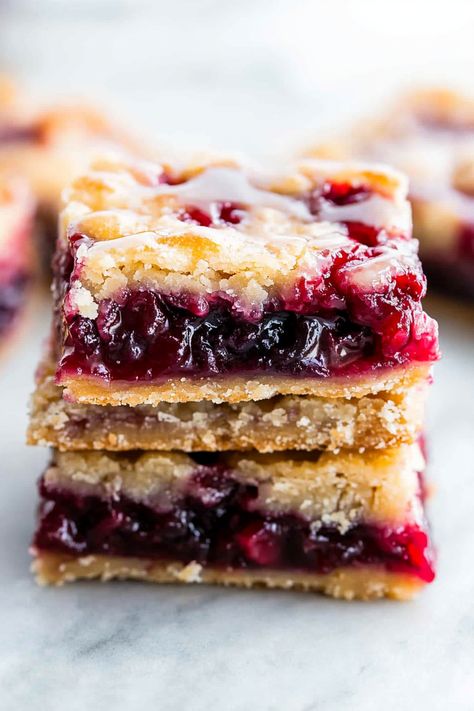 These cherry pie bars are both delicious and visually appealing! They are a homemade treat that's simple to prepare, slices beautifully, and serves effortlessly. Feel free to use any type of pie filling! Is there a sight more charming than a dessert adorned with cherries or strawberries? I adore the vibrant hues and delightful tastes, Homemade Cherry Pie Bars, Cherry Pie Bars Recipe, Cherry Pie Filling Recipes, Cherry Pie Bars, Homemade Cherry Pies, Types Of Pie, Cherry Bars, Pie Filling Recipes, Pie Bars