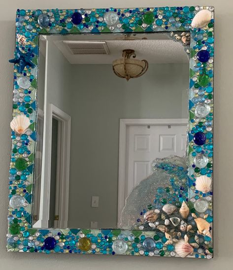 Hand crafted mirror with jewels and seashells incased in resin, one of a kind mirror. Mermaid Bathroom Ideas Diy, Seashell Mirror Diy, Plastic Spoon Mirror, Seashell Bathroom Decor, Decorated Mirrors, Seashell Mirrors, Diy Mirrors, Beach Mirror, Decorated Mirror