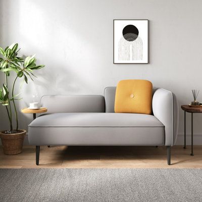 Add a contemporary design and a pop of color to a cozy seating area or living room with this chaise-inspired loveseat. We love all the mid-century details from the low-profile back and round arm to the sleek, black-finished tapered legs. The compact frame is made from engineered wood, and it's wrapped in polyester fabric in a solid color of your choice. Inside, this piece is filled with foam and pocket springs to support you while you relax with a good book. A yellow toss pillow with a button tu Cozy Seating Area, Upholstered Chaise Lounge, Compact Sofas, Upholstered Chaise, Toss Pillow, Modern Sofa Sectional, Wooden Side Table, Modern Sectional, Loveseat Sofa