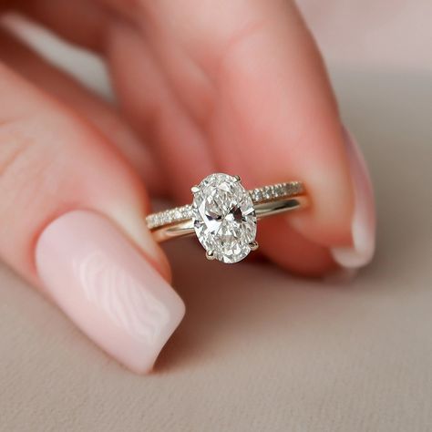 ENGAGEMENT RING DETAILS✧ Center Stone Weight: 1.50CTW (9*6MM)✧ Center Stone: Oval Cut✧ Center Stone Type: Moissanite✧ Side Stone Weight: 0.10CTW✧ Side Stone: Round Brilliant Cut✧ Moissanite Details: DEF Color, VVS+ Clarity✧ Band Width: Approx. 1.80MM WEDDING BAND DETAILS✧ Stone Weight: 0.40CT✧ Stone Cut: Round Brilliant✧ Stone Type: Moissanite✧ Moissanite Detail: DEF Color, VVS+ Clarity✧ Band Width: Approx. 1.80MM METAL DETAILS ✧ Metal: Solid Gold✧ Metal Purity: Available Options 10K | 14K | 18K