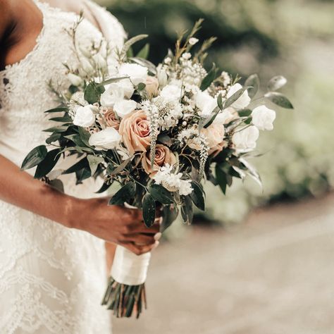 A lush bohemian style white and cream hand-tied bouquet designed with a selection of seasonal blooms such as Roses, Spray Roses, Wax Flower, Veronica and Lisianthus with lush accenting greenery. The stems are artfully wrapped with a double-satin Ivory ribbon for a luxurious finish. Soft Fall Bouquet, Bridal Bouquet Neutral Colors, Vow Renewal Bouquet, Sage Green And Blush Flowers, Sage Green And Light Pink Wedding Bouquet, Boho Style Wedding Bouquet, Earthy Bouquet Wedding, Boho Bridal Bouquet Spring, Beachy Wedding Bouquets