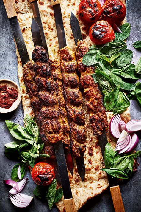 For Persians, kabab koobideh is an institution. The word ‘kebab’ (or kabab, as Persians call it) means ‘to grill’, usually over fire. The first kebabs were made by Persian soldiers who would grill meats on their swords, hence the traditional flat skewers Persians use today – you can buy them online if you want to serve them this way. Although we only have a few different varieties of kebab, for me, this is the simplest yet most delicious. Sabrina Ghayour Recipes, Persian Food Photography, Kebab Food Photography, Kubideh Kebab, Iranian Food Photography, Kabab Food Photography, Persian Food Traditional, Iranian Kebab, Persian Kebab Recipe