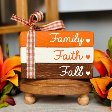 NEW BOOK STACK SIZE AVAILABLE!  This cute fall wooden book stack bundle is the perfect addition to your fall tiered tray decorations. It will bring the cozy fall feel to your home and look perfect wherever you decide to put it. Whether it be on a tiered tray, fall farmhouse mantle, bookshelf or as part of an autumn decorative centerpiece. All of our mini book stacks and larger size bookstacks are handmade & hand painted. ❤PLEASE READ DESCRIPTION, PROCESSING TIMES & ESTIMATED SHIPPING DATES IN ITS ENTIRETY.❤ ❤ SIZE: WE ARE NOT RESPONSIBLE FOR FAILURE TO READ DIMENSIONS OR PROCESSING TIMES ORIGINAL MINI BOOK STACK SIZE: 2.25" tall 3.5" wide 2.25" deep NEW LARGER BOOK STACK SIZE: 2.25" tall 5" wide 3.25" deep PLEASE REFER TO OUR SHOP BANNER PHOTO THAT SHOWS HOW THE SIZE DIFFERS. RIBBON, WORDI Books Made Out Of Wood, Wooden Book Decor, Mini Book Stacks Diy, Mantle Bookshelf, Wood Books, Fall Tray, Fall Autumn Decor, Fall Tiered Tray Decor, Faux Books