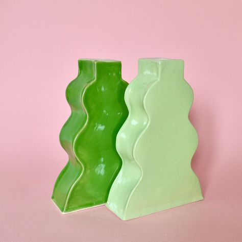 Ceramic, wavy, slab vase in lime green, made entirely by hand in my London studio. These unique vases were hand built with stoneware clay in a contemporary wavy shaped design, before being glazed glossy green with a white interior. This unique vessel would be ideal as a decorative focal point, or to hold your favourite blooms.  Each vase measures 21cm tall, 14cm wide and 5cm deep. Slab Ceramics Ideas, Slab Vase, Funky Vases, Ceramic Forms, Mugs Ideas, Clay Inspo, Slab Ceramics, Pottery Inspo, Handmade Ceramic Vase