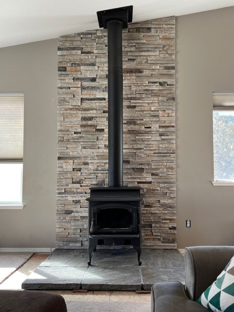 Stone Behind Wood Burning Stove, Wood Stove Center Wall, Pellet Stove Back Wall, Stone Wood Stove Hearth, Wall Behind Pellet Stove Ideas, Stone Wall Behind Wood Stove, Behind Wood Stove Wall, Stone Behind Wood Stove, Wood Stove Back Wall Ideas