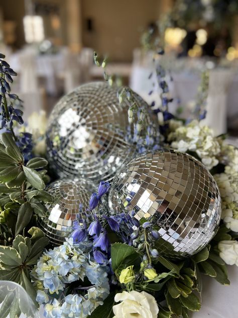 Add some sparkle to the party with a disco ball, or two. Our disco themed wedding concepts can be viewed below and if you would like to discuss this concept for your wedding, just contact us. Disco Ball Decor Wedding, Disco Ball Winter Wedding, Wedding Centerpieces Disco Ball, Wedding Taylor Swift Theme, Disco Ball Wedding Decor Table, Disco Ball Florals, Country Disco Wedding, Wedding Table Centerpieces Disco Ball, Disco Centerpieces 70s Party