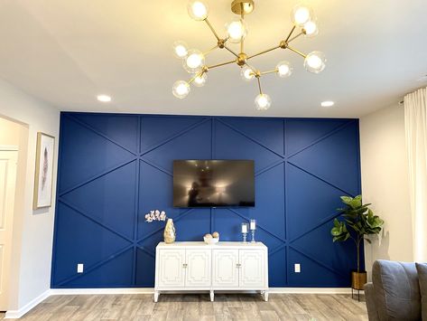 Royal blue geometric accent wall.  This wall is the attraction of this living room.  The spunk chandelier adds some glam to the whole look. Royal Blue Wall Paint Bedroom, Royal Blue Walls Bedroom, Royal Blue Accents Living Room, Living Room Designs Royal Blue, Royal Blue Bedroom Walls, Royal Blue Accent Wall Living Room, Royal Blue Walls Living Room, Royal Blue Accent Wall Bedroom, Royal Blue Wall Paint