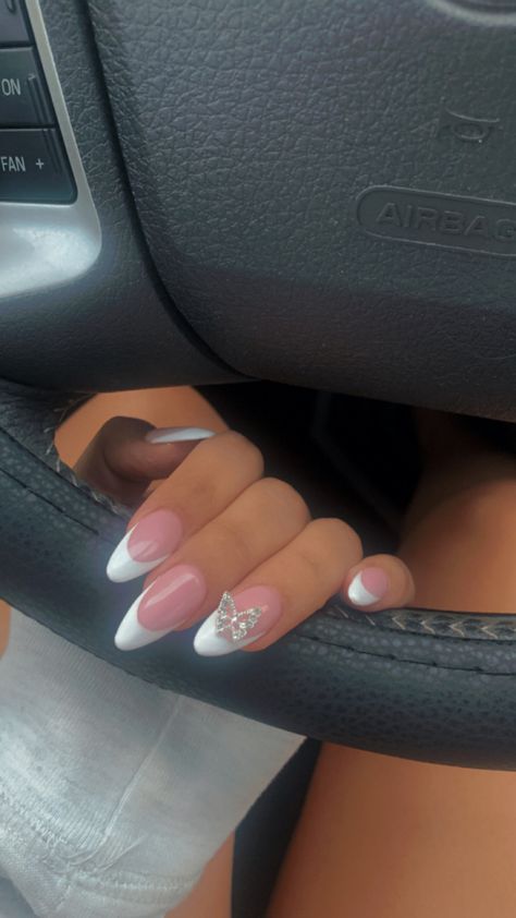 Oval Nails Designs Butterfly, Nails Almond With Diamond, French Tip Nails With Butterfly Charm, Almond Nails With Butterfly Charm, White Butterfly Nails Almond, Almond French Tip Nails With Charms, French Tip With Butterfly Charm, Butterfly Diamond Nails, Almond French With Gems