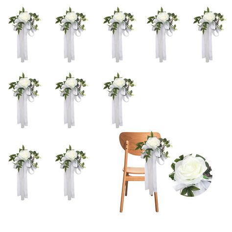 PRICES MAY VARY. PREMIUM MATERIALS: Experience the silky touch of our artificial roses, beautifully made from high-quality silk cloth, complemented by clear textured green leaves made of durable plastic for a lifelike and long-lasting appeal. EASY TO USE: Instantly add elegance to your party celebration by simply draping the artificial wedding aisle chair flower on the chair's back or tying it with a ribbon. EASY TO CLEAN: Maintaining our artificial wedding chair flowers is a breeze; it can be w Wedding Decorations For Chairs, White Flowers Wedding Ceremony, Wedding Pew Decorations Church, Chair Decor For Wedding, Church Aisle Decorations Wedding, Wedding Isles Decoration, Church Decorations Wedding, Wedding Aisle Chair Decor, Wedding Aisle Chair Decorations