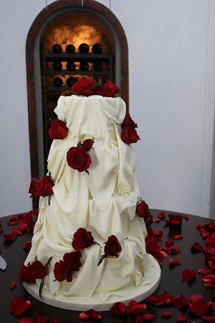 Claudine and Russel's White chocolate and red Roses wedding cake Red Roses Dessert Table, Wedding Ideas Red Roses, White Rose Cake Wedding, Wedding Cakes Roses, Red Theme Wedding Cake, White Wedding With Red Roses, White Cake Red Roses, Snow White Themed Wedding, Red Rose Wedding Dress