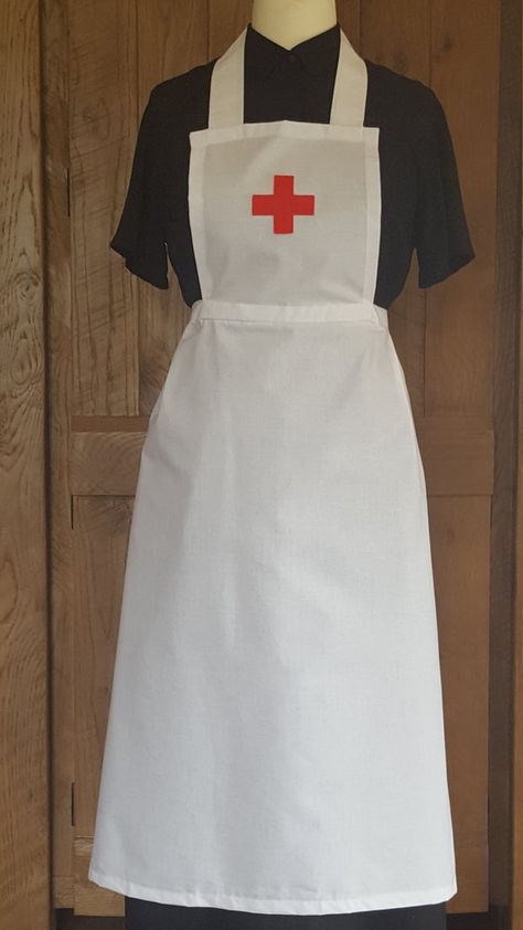 Handcrafted Red Cross style adult World War I Nurse apron uniform, material: 100 % cotton A white apron with the Red Cross emblem displayed on the bib,Long waist straps to fit various sizes.  skirts part length: 28 inch  Ideal for history days, WW1 day, World book day, WWI Nurse Apron, Nurse Fancy Dress, Apron Uniform, Maid Hat, Maid Fancy Dress, Gothic Wedding Theme, Apron White, Apron Pinafore, White Victorian