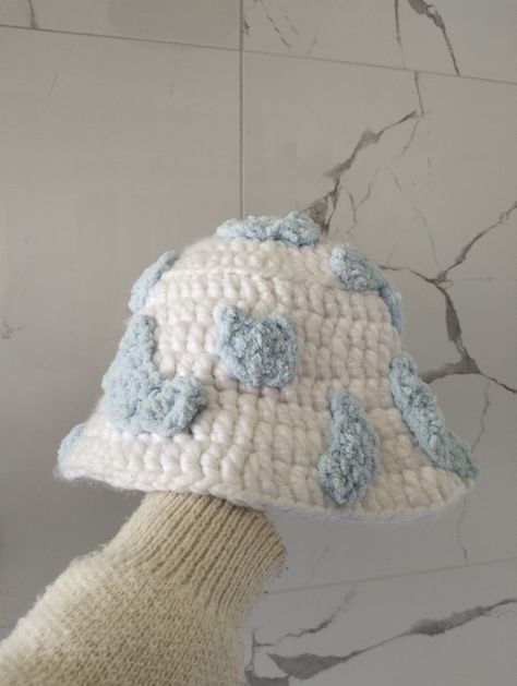 A white crocheted bucket hat with light blue cow print. Fluffy Cow Crochet, Cloud Bucket Hat, Crochet Bucket Hat Free Pattern, Easy Crochet Bucket Hat, Cow Bucket Hat, Fluffy Cow, Cow Crochet, Crochet Accessory, Fluffy Cows