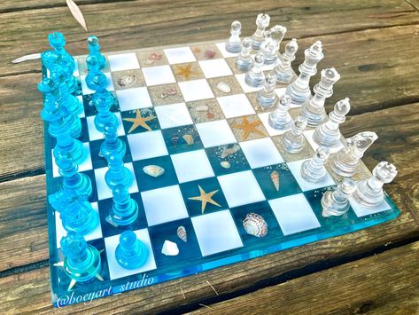 "Product details: This ocean chess board is made with natural element. It is great decoration in many environments and all rooms in a home. It would be a great gift for your friends who love ocean.  Product size: 12\"x12\" Materials & care: Made of couple layers of resin with non-toxic pigment powder. Every purchase from Boey Art Studio will benefit the cleaning of our Ocean and save whales & dolphins.  More products at my ig page:  https://instagram.com/boeyart_studio?igshid=1c5r2rftc1tud boeyart_studio  Shop: etsy.com/ca/shop/BoeyArtStudio Handmade with Love💝" Epoxy Resin Chess Board Diy, Resin Game Board, Chess Resin Idea, Resin Board Games, Resin Chess Set Ideas, Resin Chess Board Ideas, Chess Resin, Diy Chess Board, Resin Chess Board