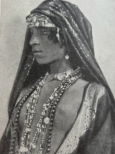 Wearing an embroidered head shawl, worn over a bejewelled turban, necklace of coins, earrings and coloured strings. Picture taken from the book People of all Nations. Egyptian Headdress, Egyptian Hairstyles, Egyptian Aesthetic, Egyptian Accessories, Egyptian Clothing, 90s Runway, 90s Runway Fashion, Vogue Archive, Veil Hairstyles