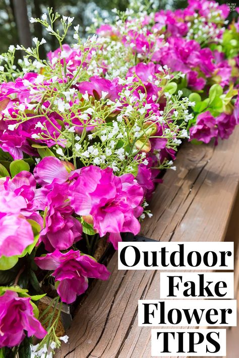 Fake flowers are the way to go if you want fuss free deck railing and flower boxes accenting your home's exterior. Follow these outdoor fake flower tips for nice arranging and to lessen fading from the sun. Outdoor Fake Floral Arrangements, Fake Flower Planter Boxes, Planters With Fake Flowers, Landscaping With Fake Flowers, Diy Fake Outdoor Planters, Balcony Floral Decor, Fake Flowers In Window Boxes Diy, Artificial Flowers In Window Boxes, Plant Fake Flowers Outside