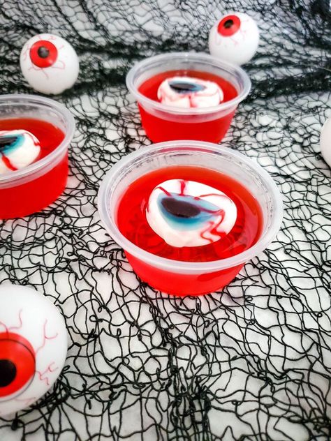 Eerie! Spooky! Wacky! These are just some of the expressions your guests should have this coming Halloween. Nothing on the menu will achieve that expression as compared to these Eyeball Jello Shots. These deliciously boozy treats are perfect for a spooky Halloween party.Making these Eyeball Jello Shots is surprisingly easy and straightforward. However, note that the recipe includes alcohol and is not fit for kids. By now, you probably have a lot of questions concerning the Eyeball Je… Adams Family Snacks, Eyeball Treats Halloween, Hello Shots Halloween, Halloween Treat Diy, Halloween Diy Crafts For Adults, Halloween Jello Ideas, Halloween Food Board Ideas, Eyeball Jello, Halloween Jello Shots