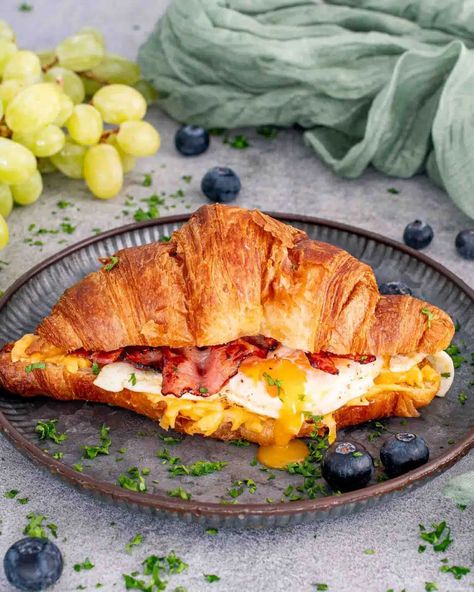 These Bacon, Egg, and Cheese Croissants are a breakfast dream! Crispy bacon, melted cheddar, and perfectly cooked eggs in a flaky croissant. Ready in just 30 minutes! #BreakfastRecipes #CroissantSandwich #EasyMeals #QuickBreakfast #DeliciousEats Croissant Breakfast Sandwiches, Croissant Breakfast Sandwich, Leftover Breakfast, Cheese Croissant, Croissant Sandwich, Croissant Breakfast, Croissant Recipe, Crispy Cheese, Bacon Egg And Cheese