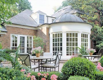 French-Style Solarium Inspired by a French chateau dining room, this enchanting sun room is a stylish complement to the stately brick Georgian home. A copper-clad roof and Doric columns reinforce the classical theme. The rooms curve provides an enticing transition to the outdoors. Sunrooms Ideas, Sunroom Addition, Clapboard Siding, Sunroom Decorating, Suburban House, Cottage Style Homes, Casa Vintage, Sunrooms, Have Inspiration