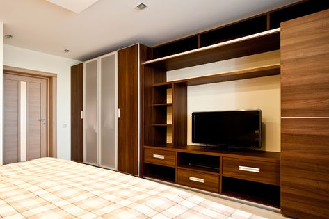 Tv wardrobe design which makes the most out of your designated wardrobe space Wardrobe With Tv Unit, Simple Tv Unit Design, Bedroom Tv Unit Design, Tv Unit Bedroom, Bedroom Wall Units, Bedroom Tv Stand, Bedroom Wardrobe Design, Modern Wall Units, Wall Unit Designs