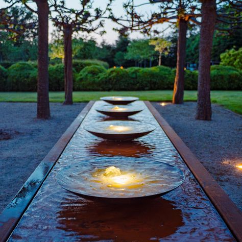 With its contemporary design, the Adezz Corten steel rectangular water bowl table is a distinctive and stylish garden ornament, bringing extra ambience and dynamism to any garden space. This effect is amplified by the water bowls that rest on top of the water table. The water flows over the edge of the bowls, adding life and movement to the garden. The epitome of contemporary shimmering beauty, the integrated LED-lit fountains turn your daytime water feature into a nightmare spectacular, allowin Internal Water Feature, Water Bowl Fountain, Rectangular Water Feature, Water Feature Sculpture, Rectangle Water Feature, Restaurant Water Feature, Round Water Feature, Corten Steel Water Feature, Water Bowl Garden