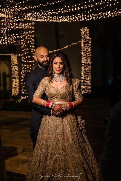 Beautiful golden lehenga for the reception party. See more on wedmegood.com  #wedmegood #indianwedding #indianbride #gold #bridallehenga #bridallehengacholi #lehenga #lehengacholi #couples #couplephotography #couplegoals Golden Reception Lehenga, Golden Lehenga Brides Receptions, Golden Lehenga Brides, Golden Bridal Lehenga, Extravagant Outfits, Golden Lehenga, Structured Gown, Reception Outfits, Groom Photoshoot