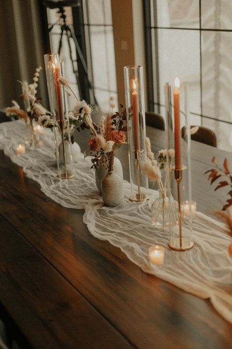 love the taper candles Burnt Orange Taper Candles, Stick Candle Centerpieces, Terracotta Taper Candles, Wedding Table With Taper Candles, Wedding Table Taper Candles, Enclosed Taper Candles Wedding, Taper Candles In Glass Cylinders, Long Wedding Table Flowers, Candle Stick Wedding Table Decor