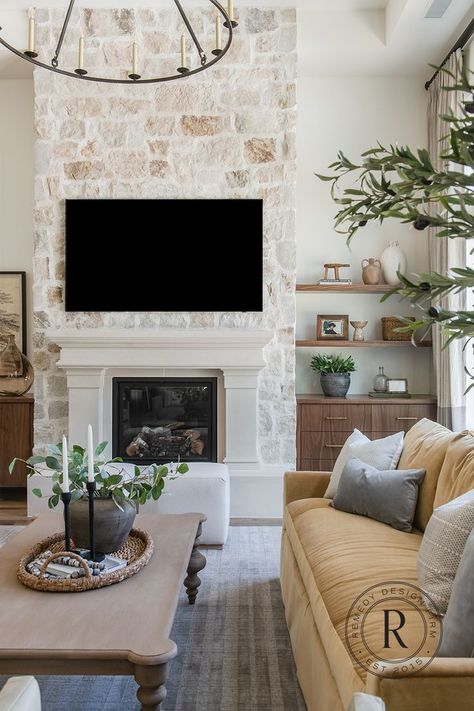 As the weather finally starts to cool down, we're dreaming of cozy fall nights by beautiful cusom stone fireplaces, like this one! Fireplace With Cutouts On Side, Rock Wall With Fireplace, Mantel Over Stone Fireplace, 20ft Fireplace Wall, Neutral Stone Fireplace, Electric Fireplace Stone Wall, Modern French Country Fireplace, European Farmhouse Fireplace, Stone Fireplace With White Mantle