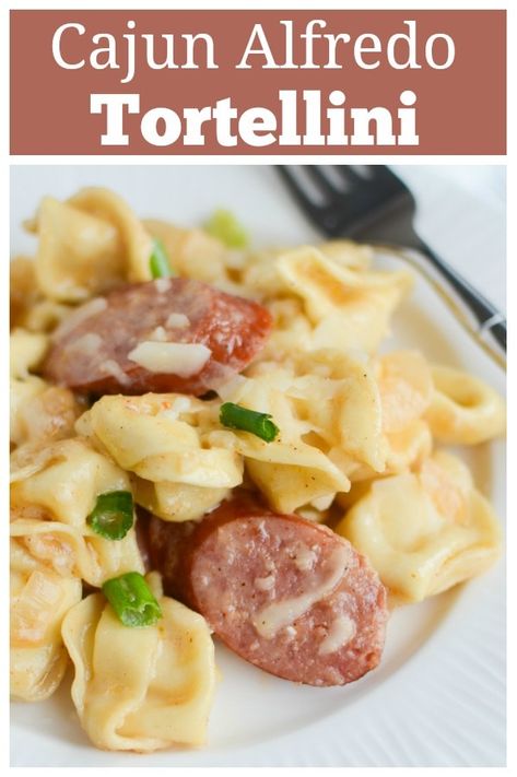 Cajun Tortellini Alfredo - delicious 20 minute weeknight dinner recipe. Tortellini and smoked sausage in a creamy cajun alfredo sauce! Sausage Tortellini Alfredo Recipes, Cheese Tortellini And Smoked Sausage, Italian Sausage Tortellini Alfredo, Keilbasa Recipes Tortellini, Tortellini Kielbasa Recipes, Tortellini And Smoked Sausage Recipes, Kielbasa Alfredo Pasta, Smoked Sausage And Tortellini Recipes, Kielbasa Tortellini Recipes