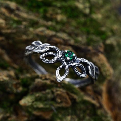 Handcrafted from sterling silver, our Emerald Elven Branch Wedding Ring for women is an enchanting and unique piece that embraces the magic of nature. With intricate details of a branch, vine, and delicate emerald, this fantasy engagement ring captures the essence of an enchanted forest. The silver leaf design adds a touch of elegance to this nature-inspired ring, making it a unique and timeless jewelry piece. Ideal for those seeking an elven aesthetic or a woodland gift. Characteristics: Metal - Recycled solid sterling silver  Stone - Cubic Zirconia Finish - Oxidized. View all silver elven rings: https://www.etsy.com/shop/TinyShinyJewel?ref=seller-platform-mcnav&section_id=47130640 Care instructions: To care for the ring, avoid contact with water and chemicals such as perfumes and lotions Emerald Jewelry Silver, Enchanted Forest Wedding Rings, Fantasy Inspired Rings, Enchanted Forest Ring, Fantasy Rings Aesthetic, Elven Ring Engagement, Forest Engagement Ring, Elven Engagement Ring, Nature Inspired Wedding Rings