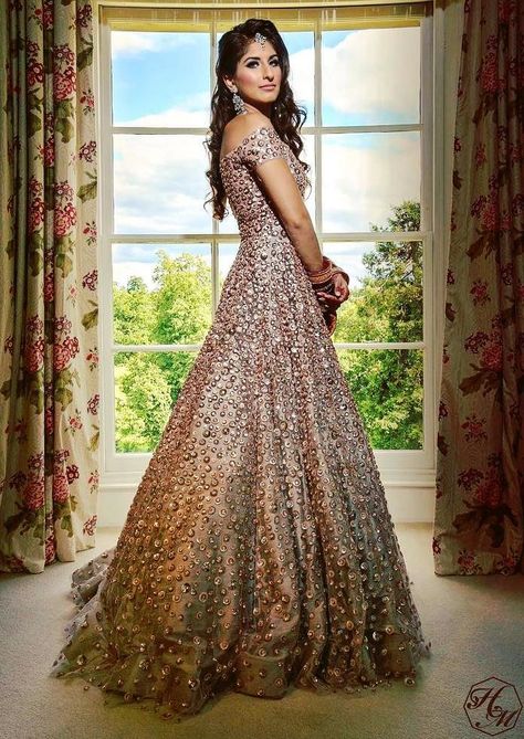 How stunning does this bride look in a largely flared evening gown, perfect for an engagement or reception ceremony? #manishmalhotra #designer #lehenga #indianbride #indianwedidng #modern #lehenga Marriage Reception Dress, Indian Wedding Reception Gowns, Indian Reception Outfit, Indian Wedding Reception Outfits, Wedding Reception Gowns, Wedding Reception Outfit, Reception Outfits, Reception Gowns, Engagement Gowns