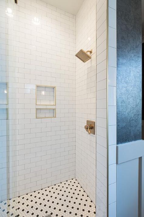 Brass schluters on tiled shower niches in a walk in shower finished with white subway tiles and black and white hexagon floors. Subway Tile Shower Niche, Schluter Tile Edge, Schluter Shower, White Subway Tile Shower, Tile Shower Niche, Marble Shower Tile, Subway Tile Showers, Guest Bathroom Remodel, Marble Showers