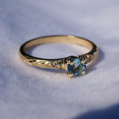 A dainty 10K Yellow Gold ring with a 4mm Aquamarine, six diamond accent stones, and beautifully engraved shoulders.  This ring is size 5.25, and can be resized. Bridgerton Engagement Ring, Dream Rings, Ring Inspo, Vintage Gold Rings, Aquamarine Engagement Ring, Jewels Rings, Fashion Statements, Aquamarine Ring, Aquamarine Rings