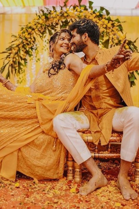 Want your Haldi ceremony to be the talk of the town? Steal the show with stunning Background Haldi Ceremony Decoration ideas we have curated for you to bookmark right away! Haldi Couple Poses, Groom Haldi Photoshoot, Haldi Ceremony Couple, Haldi Pics, Haldi Couple, Haldi Photography Ideas, Haldi Look For Bride, Haldi Pose, Groom Haldi