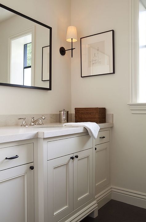 Cream powder room features a cream vanity adorned with bronze knobs placed under… Cream Bathroom Vanity, Cream Bathroom Ideas, White And Cream Bathroom, Black And Cream Bathroom, Cream Bathroom, Farmhouse Bathroom Vanity, Vanity Ideas, Transitional Bathroom, Large Bathrooms