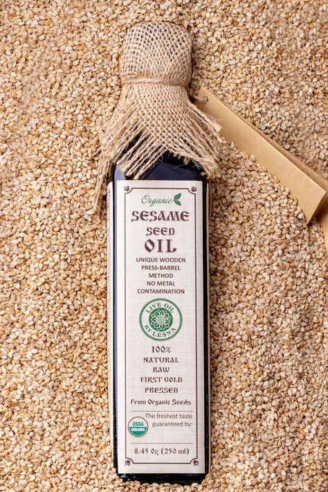 Our collection of certified organic oils are hand pressed with love using the unique wooden barrel technique that prevents the oil from touching any metal. Because it avoids oxidation, our sesame seed oil is cold-pressed and have no contact with metal, preserving intact all nutritional values and avoiding bitter taste. Our raw cold - pressed sesame is made with 100% certified organic sesame seeds, containing no additives, fillers, chemicals or preservatives. The oil is  vegan friendly and gluten-free. For Cooking and Skin Care: Our organic sesame seed oil can be used in your daily nutrition, for sauces, dips, marinades, soups or salad dressing, or used topically as a mosturizer for your hair, skin and nails, mouth pulling or massaging. Live Oil by Lesna is dedicated to bringing to your tab Mouth Pulling, Benefits Of Sesame Seeds, Sesame Seed Oil, Protein Powder Shakes, Oil Extraction, Oil Packaging, Daily Nutrition, Cold Pressed Oil, Cooking Sauces